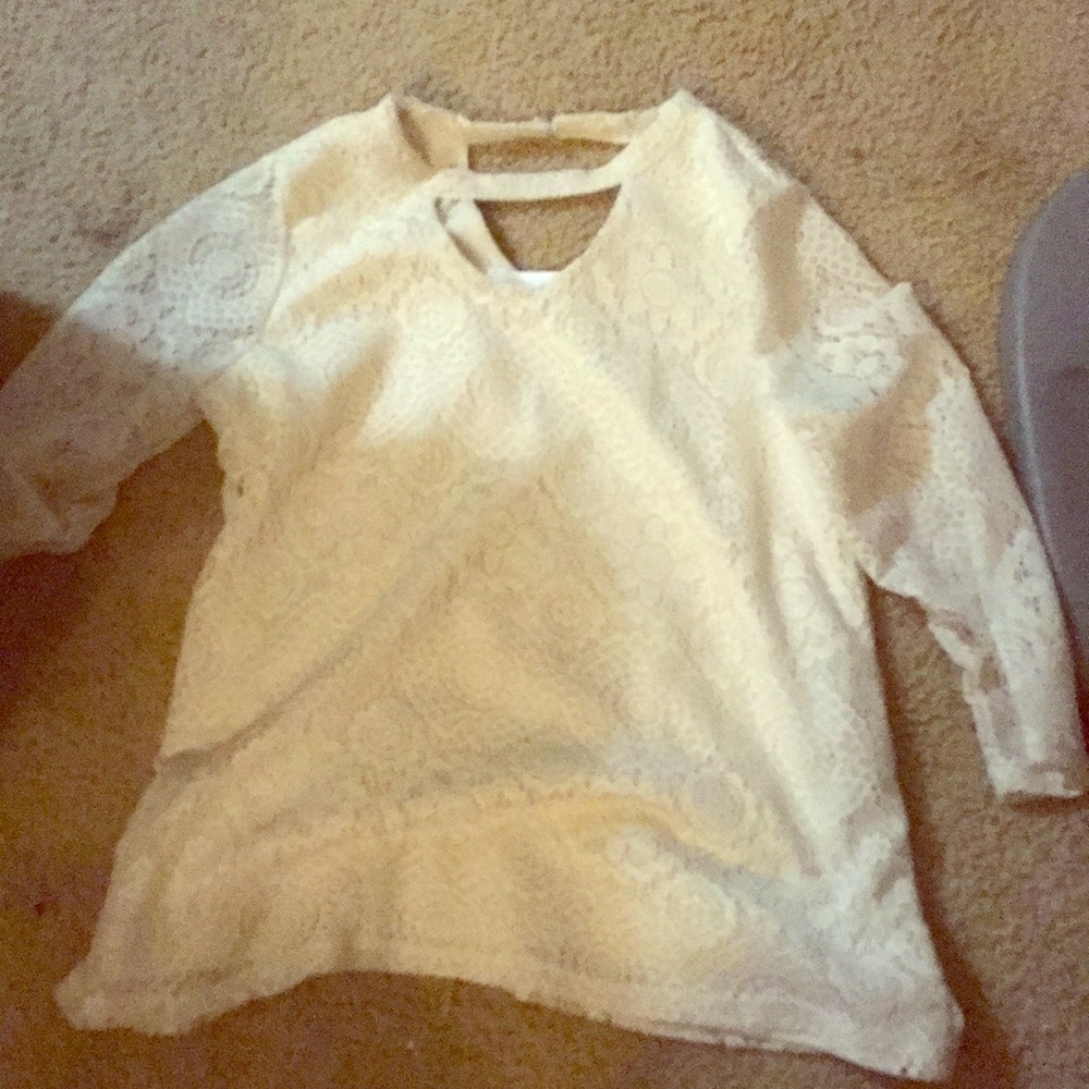 Creamy white with holes in it and never  worn once